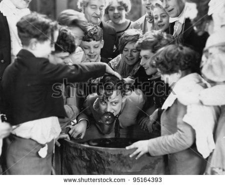 stock photo children crowded around apple bobbing 95164393