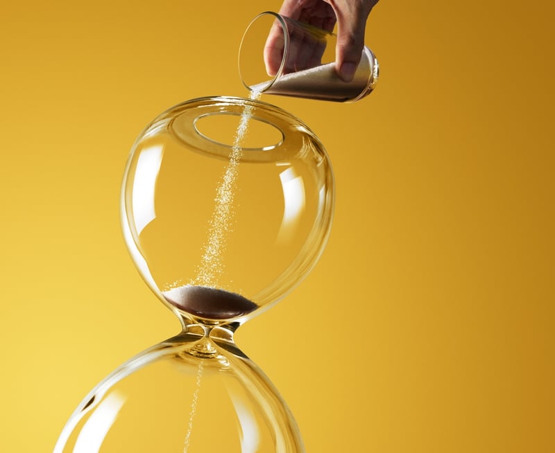 pouring sand into an hour glass