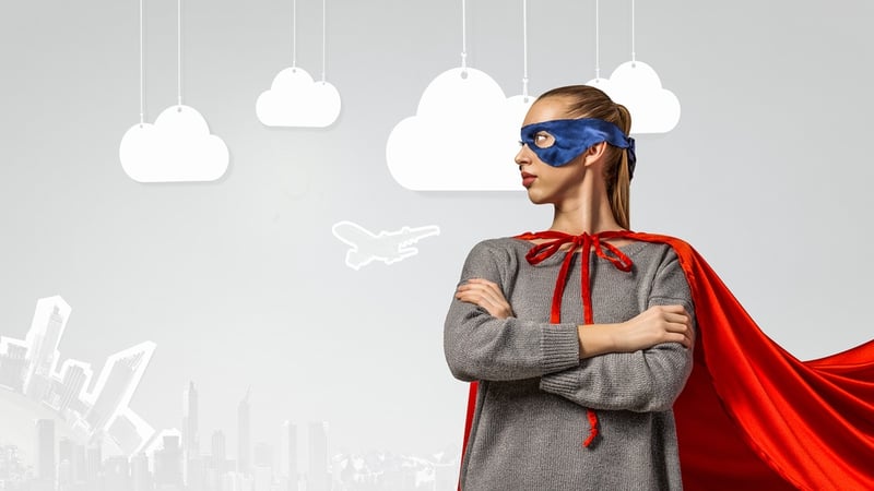 Female wearing superhero cape and mask